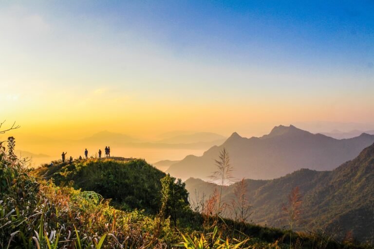 Photo Of People Standing On Top Of Mountain Near Grasses 733162 768x512